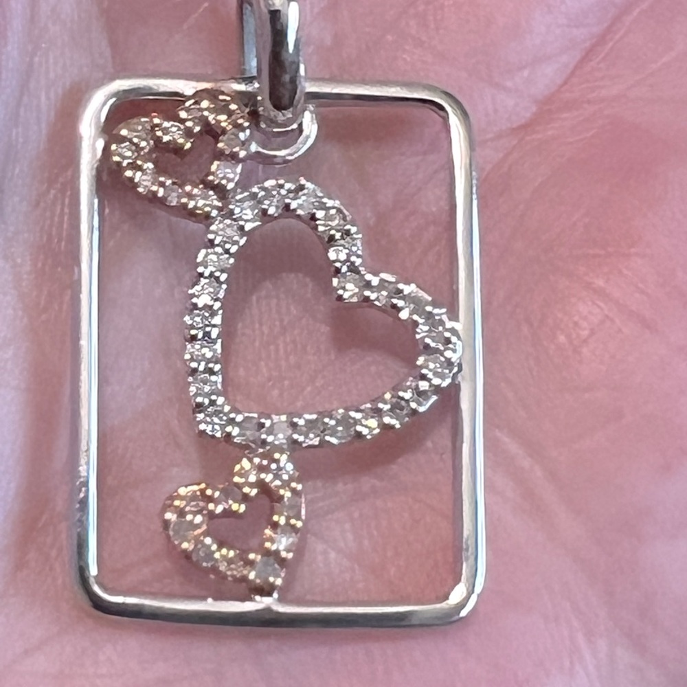 New two tone 10kt necklace, w/18” chain. Small diamond chips on the hearts.